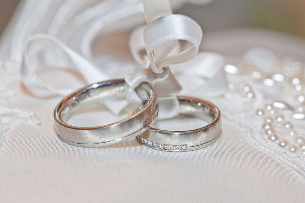 silver wedding rings tied with silver ribbon
